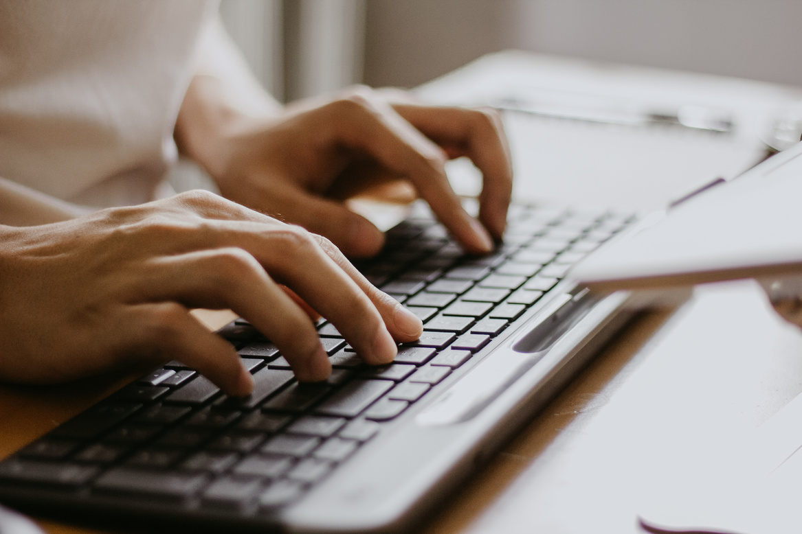 a person typing on a computer keyboard