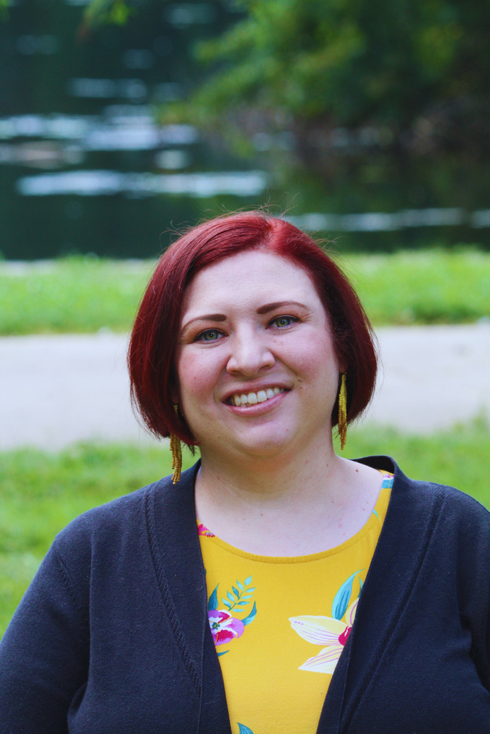 Marissa Moore is smiling with a natural background. 